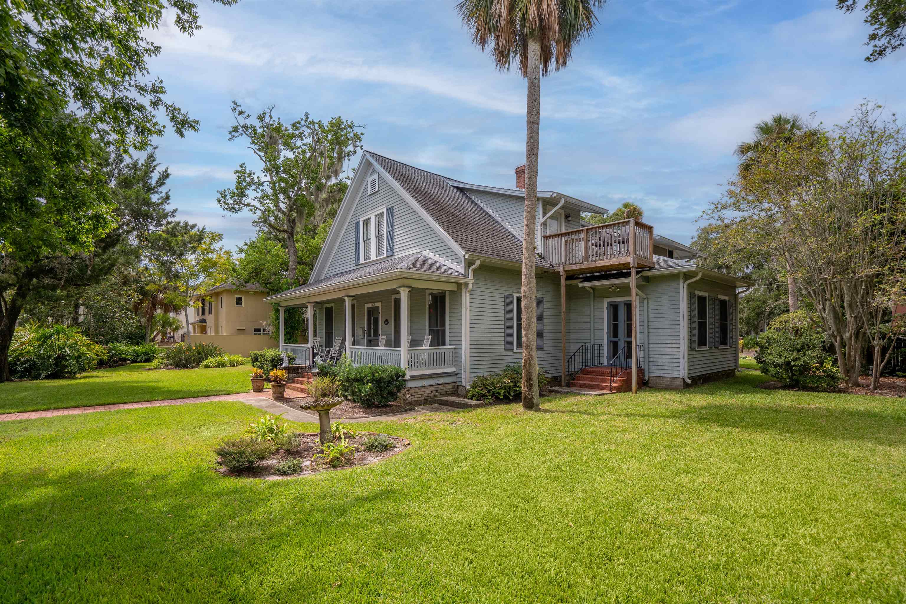 142 Marine Street St. Augustine, FL 32084 - Photo 9 of 48 a front view of a house with garden and trees