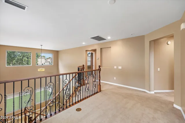 a bedroom with a bed chandelier and a window