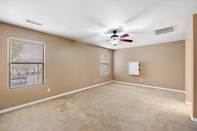 a view of an empty room with a ceiling fan