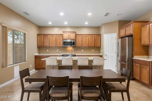 a large kitchen with stainless steel appliances lots of counter top space