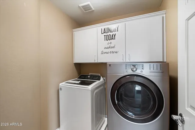 a view of an house with backyard space and a tree