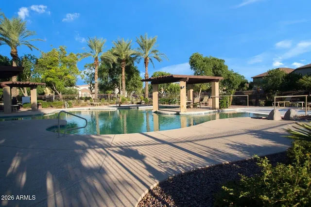 a view of a patio with a table and chairs under an umbrella