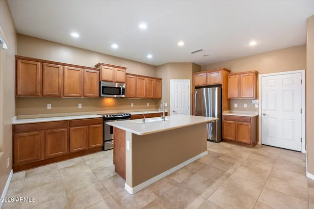 a kitchen with a stove a refrigerator and a sink