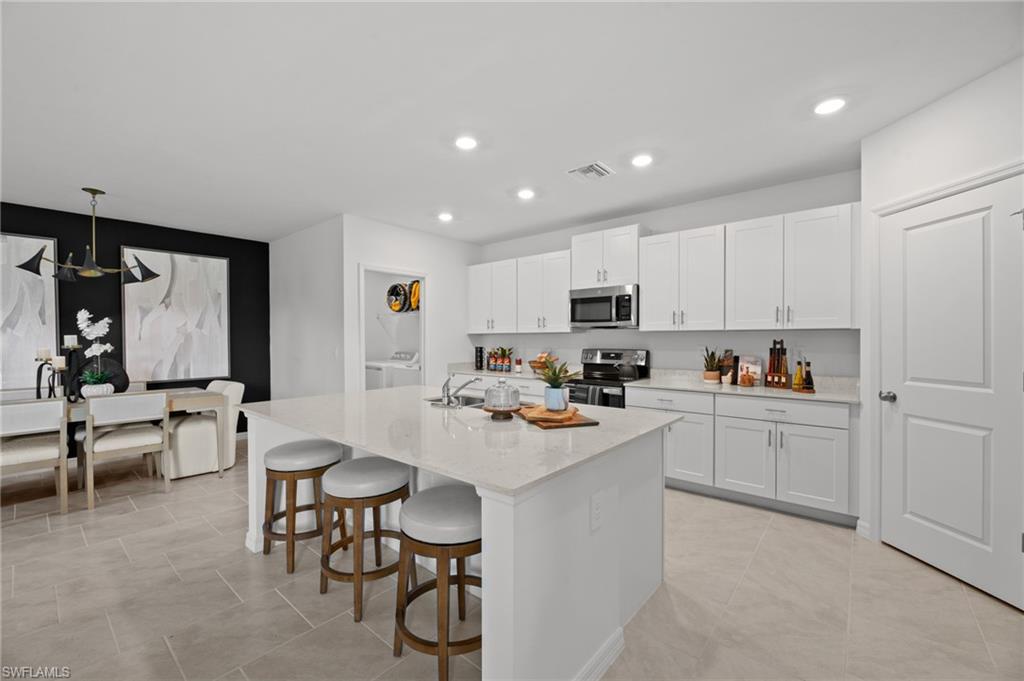 7182 Sugar Pine Way Fort Myers, FL 33966 - Photo 14 of 36 a kitchen with white cabinets and sink