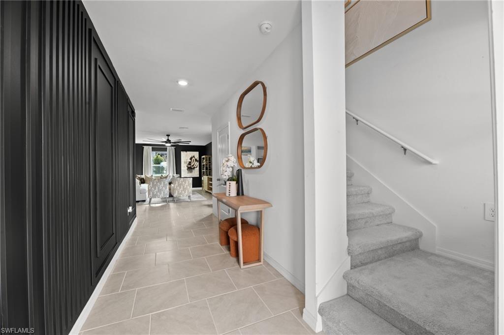 7182 Sugar Pine Way Fort Myers, FL 33966 - Photo 18 of 36 a hallway with wooden cabinets stairs and furniture