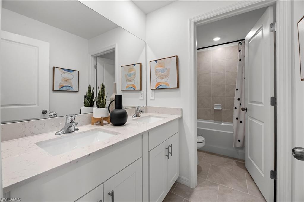 7182 Sugar Pine Way Fort Myers, FL 33966 - Photo 26 of 36 a bathroom with a double vanity sink mirror and shower