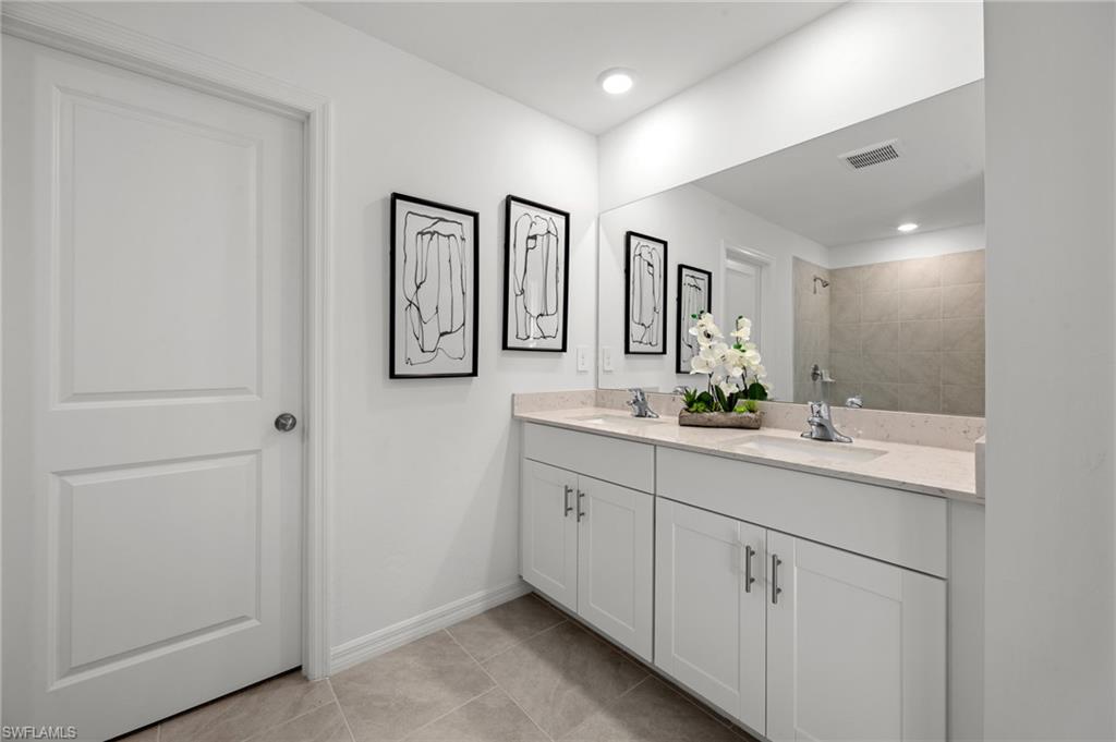 7182 Sugar Pine Way Fort Myers, FL 33966 - Photo 33 of 36 a bathroom with a double vanity sink and a mirror