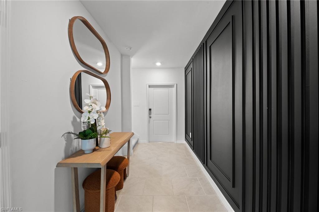 7182 Sugar Pine Way Fort Myers, FL 33966 - Photo 4 of 36 a hall way with furniture a mirror and a gate