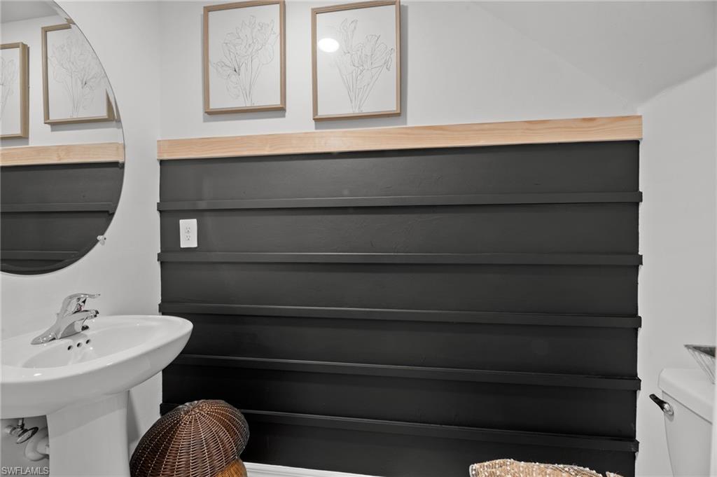 7182 Sugar Pine Way Fort Myers, FL 33966 - Photo 5 of 36 a bathroom with a sink and a mirror