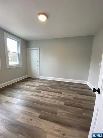 a view of a room with wooden floor and window