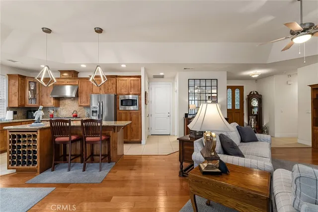 a bedroom with a bed a chair and a large window