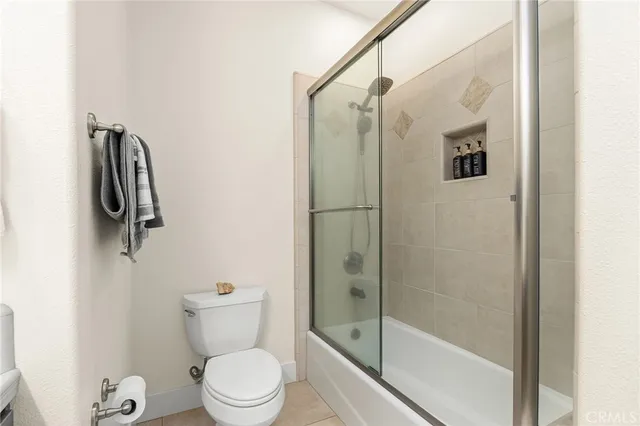 front view of a house with swimming pool and porch with furniture