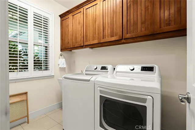 a view of a patio with couches and a table and chairs with wooden fence