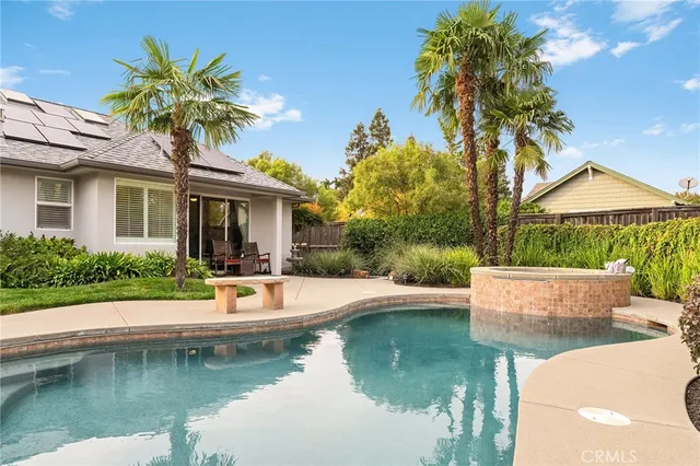 a view of a house with swimming pool and sitting area