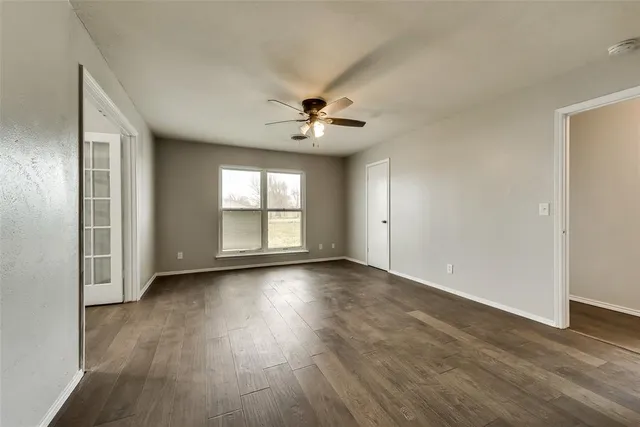 wooden floor in an empty room with a window