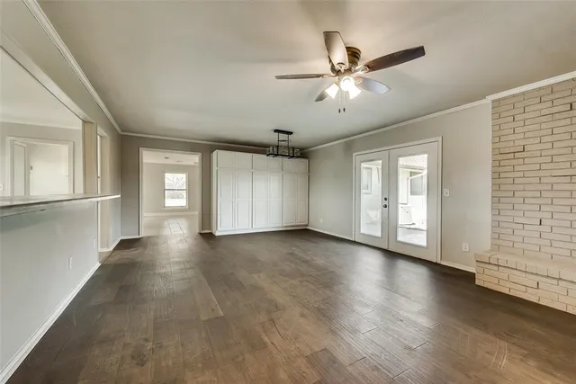 a view of a livingroom with a ceiling fan and wooden floor