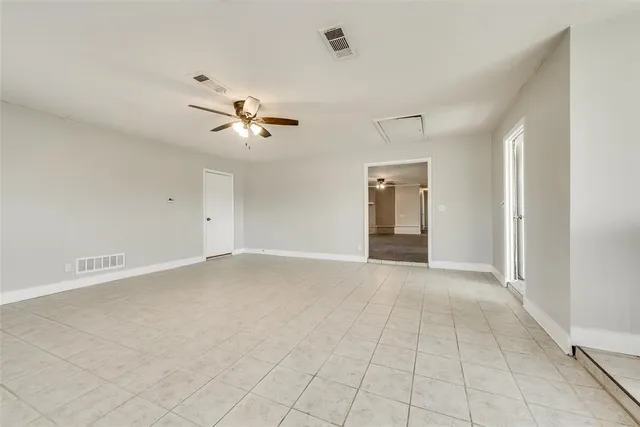 a view of an empty room with a ceiling fan