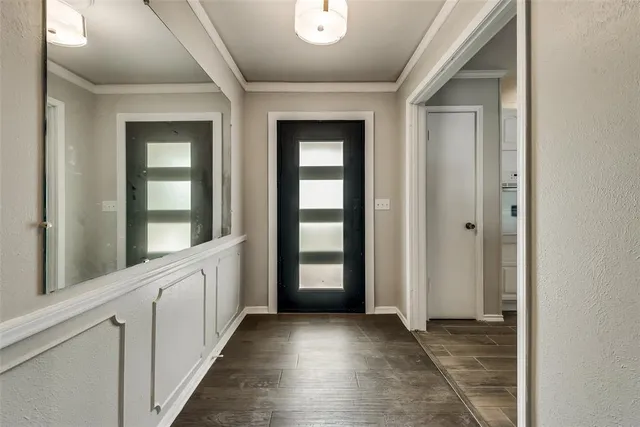 wooden floor with a window in a hall with an entryway