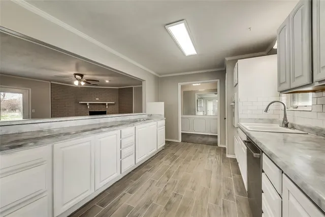 a large kitchen with kitchen island a sink stainless steel appliances and cabinets