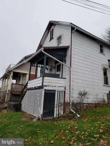 a view of a house with a small yard