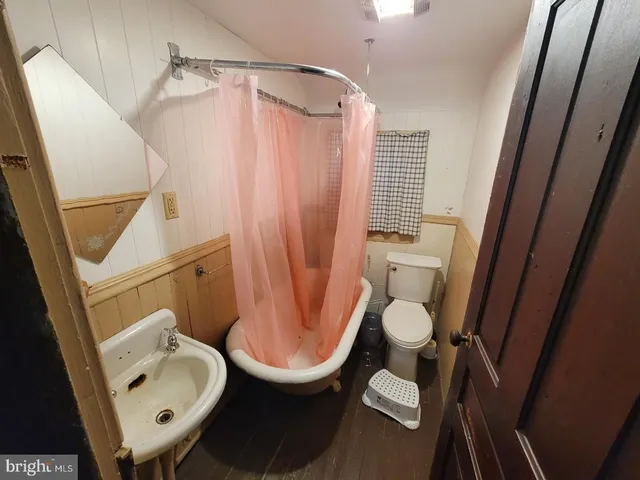 a bathroom with a toilet and a sink