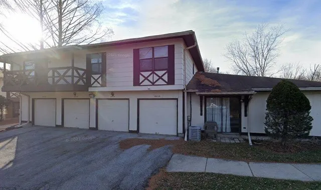 a view of a house with a yard and garage