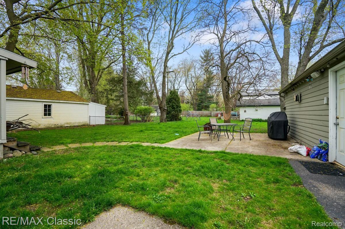 1831 South Commerce Road Walled Lake, MI 48390 - Photo 21 of 23 Partially Fenced Yard with Concrete Patio