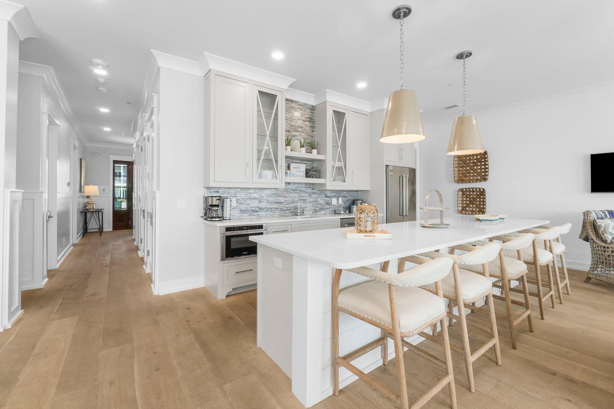 22015 Front Beach Road Panama City Beach, FL 32413 - Photo 32 of 104 a kitchen with kitchen island wooden cabinets and refrigerator
