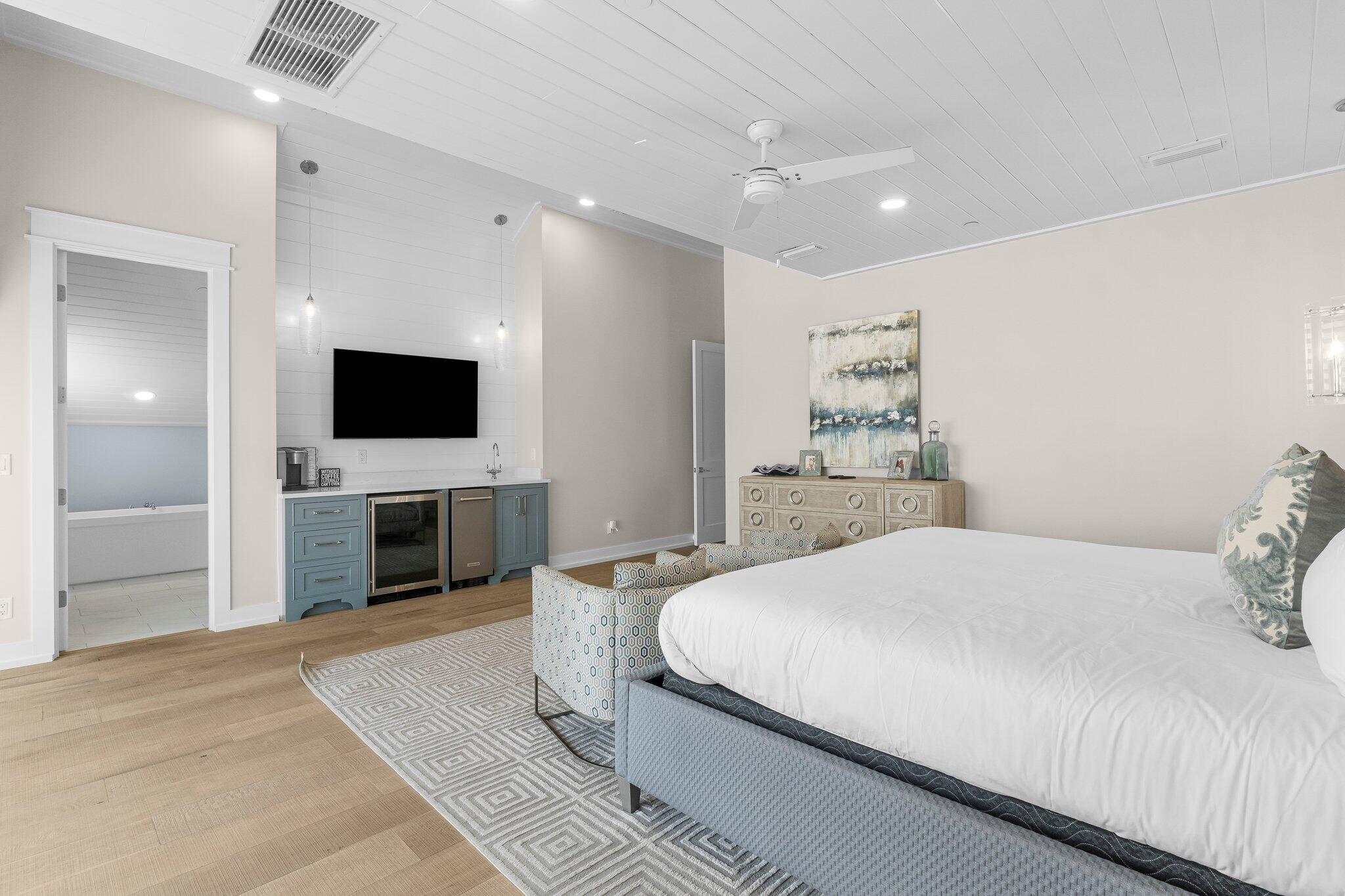 22015 Front Beach Road Panama City Beach, FL 32413 - Photo 61 of 104 a spacious bedroom with a bed and a flat screen tv