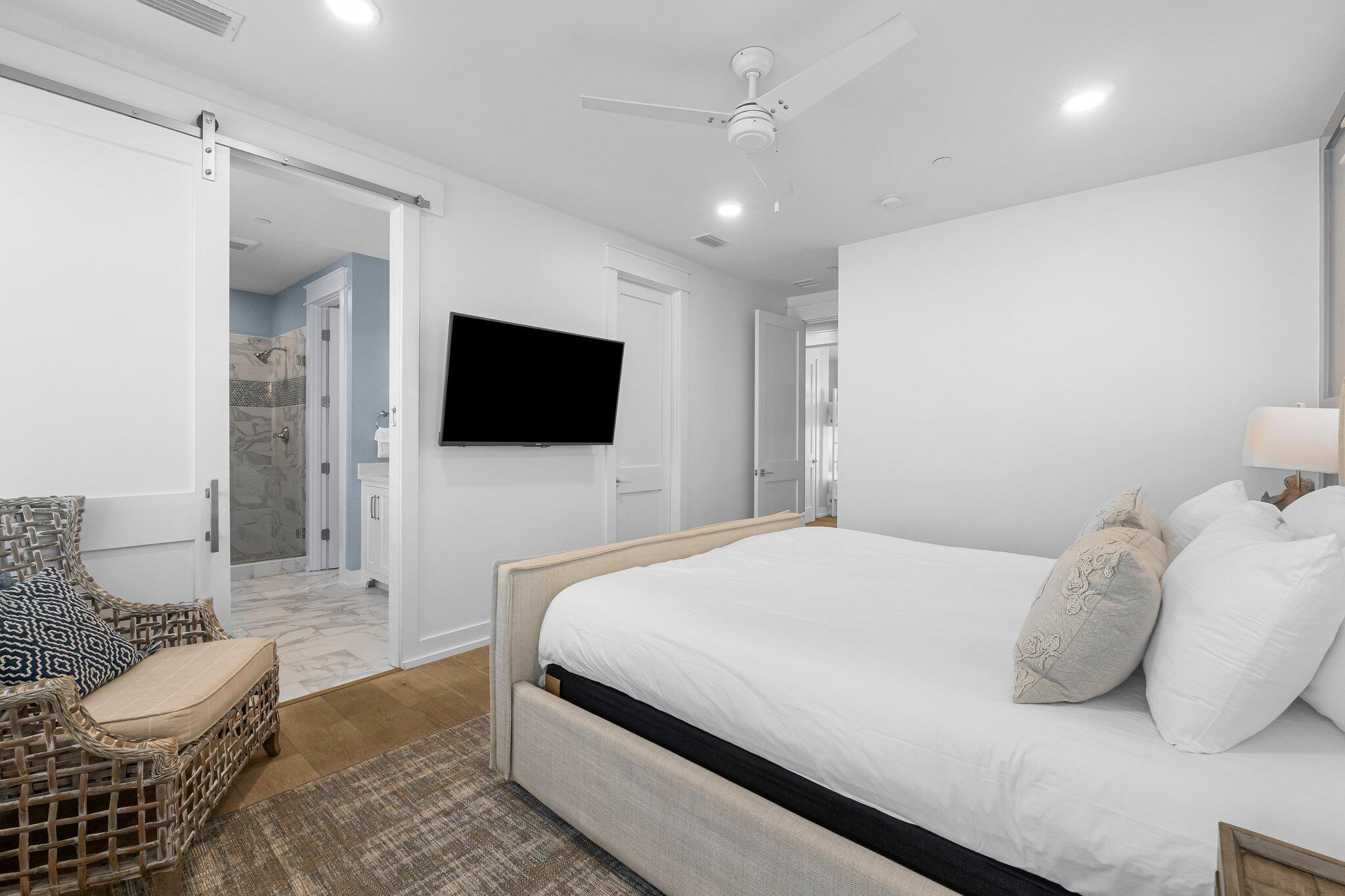 22015 Front Beach Road Panama City Beach, FL 32413 - Photo 75 of 104 a bedroom with a bed and a flat screen tv