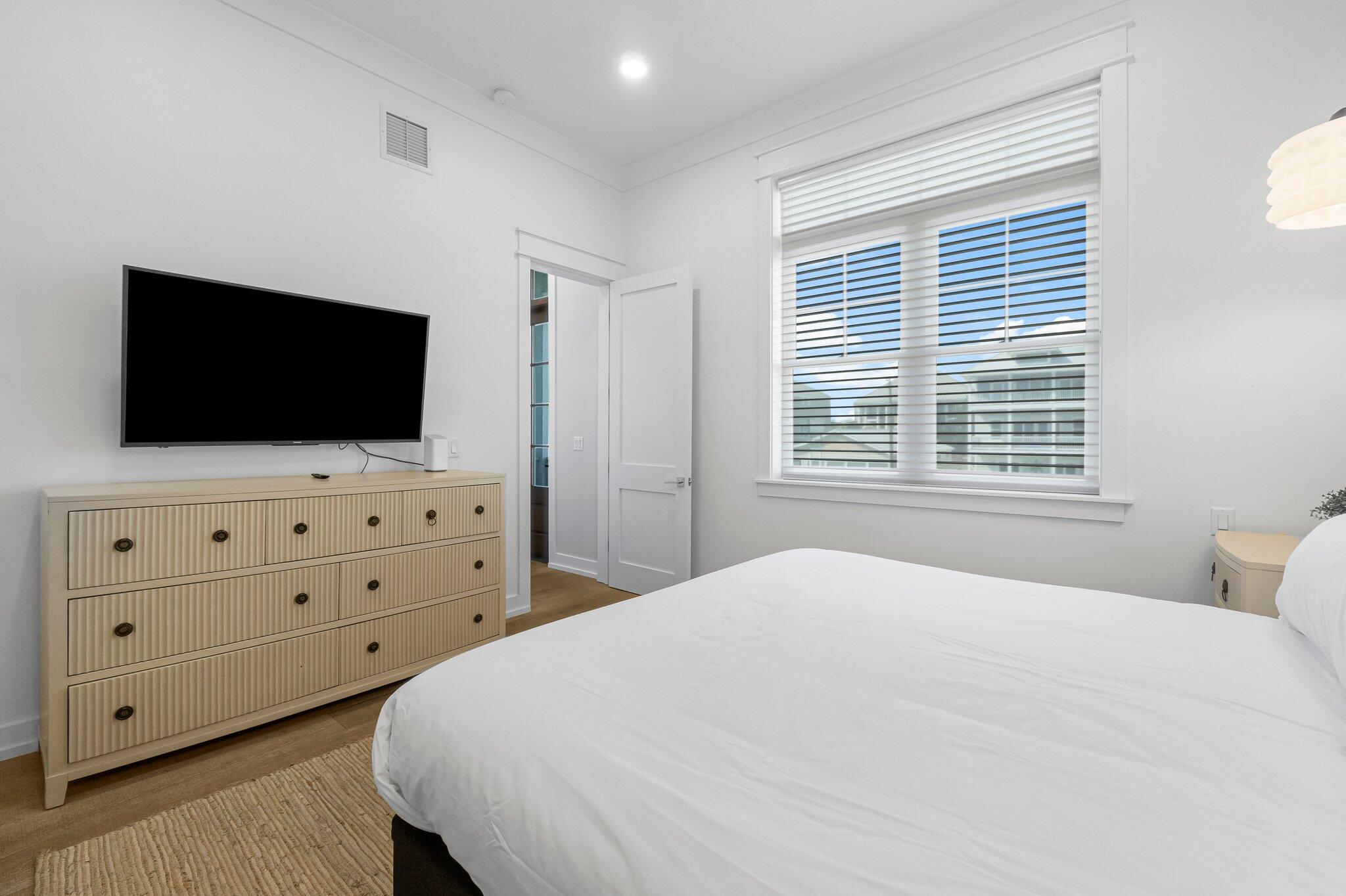 22015 Front Beach Road Panama City Beach, FL 32413 - Photo 83 of 104 a bedroom with a bed and flat screen tv