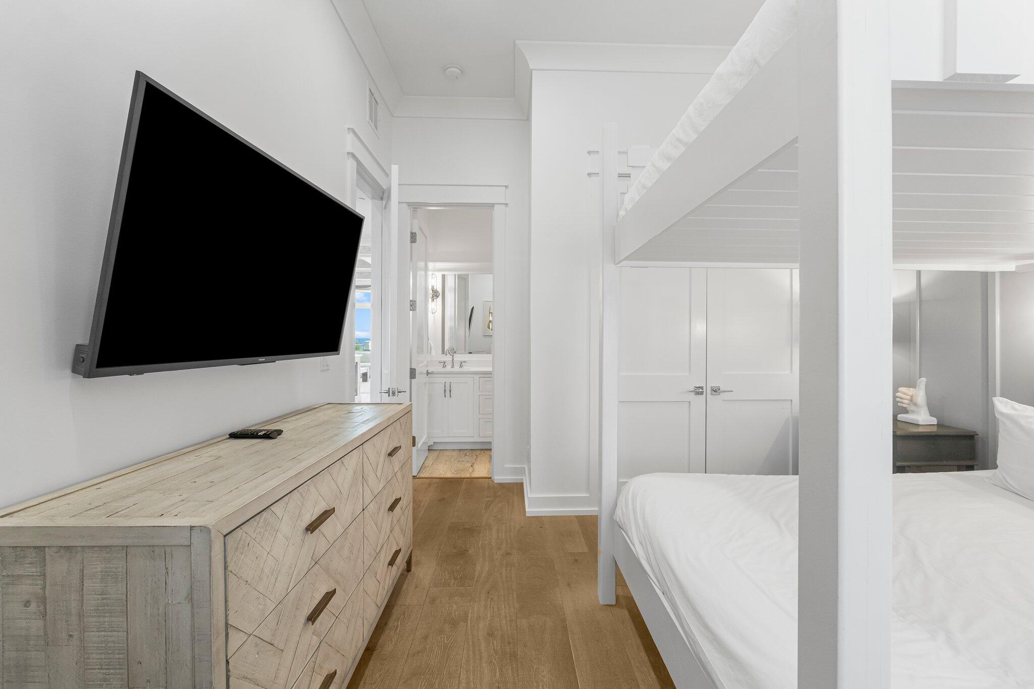 22015 Front Beach Road Panama City Beach, FL 32413 - Photo 86 of 104 a hotel room with a bed and a flat tv screen on wall