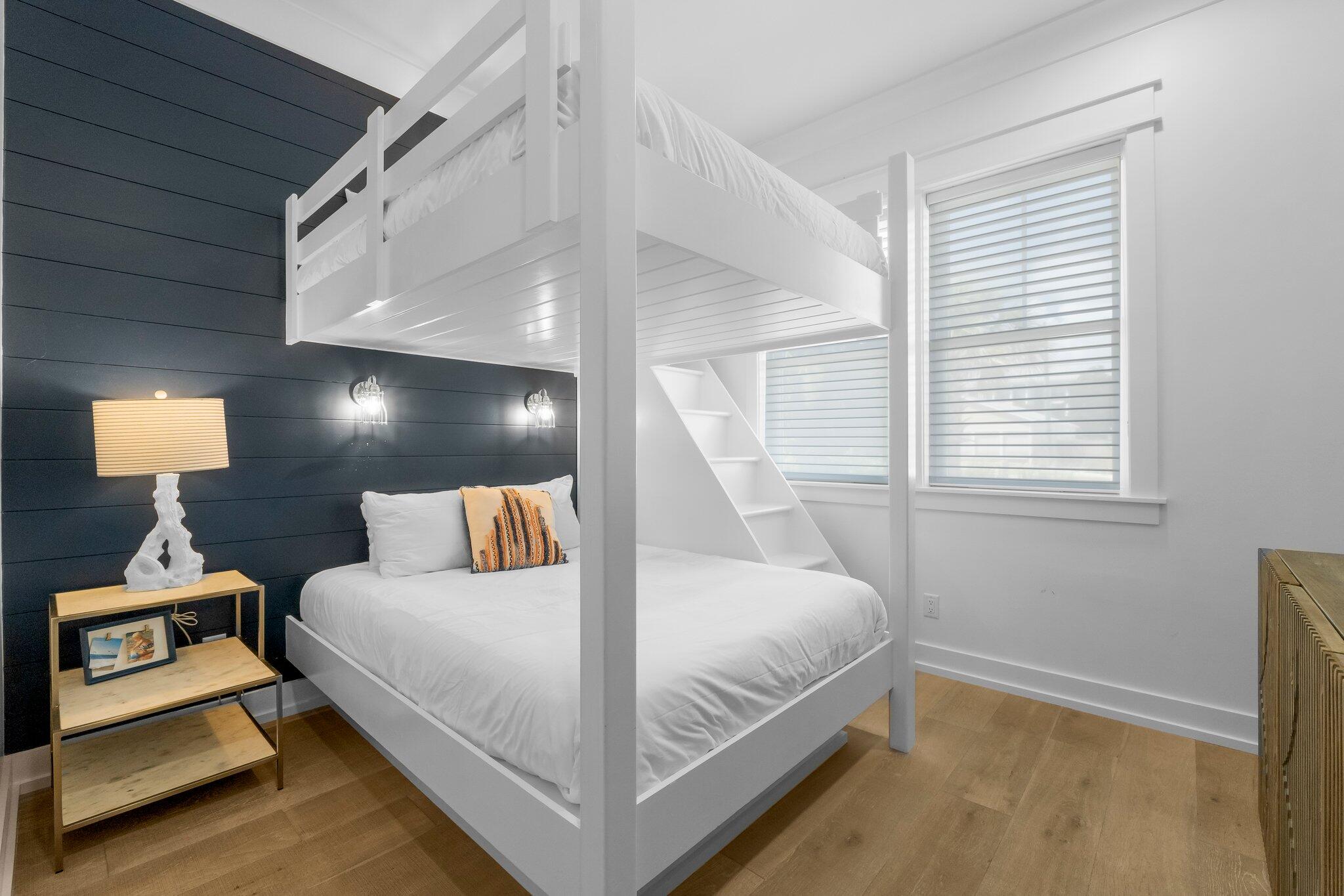 22015 Front Beach Road Panama City Beach, FL 32413 - Photo 88 of 104 a bedroom with a bed and wooden floor