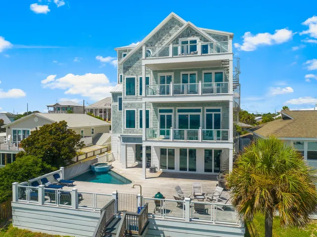 a living room with furniture and a view of kitchen