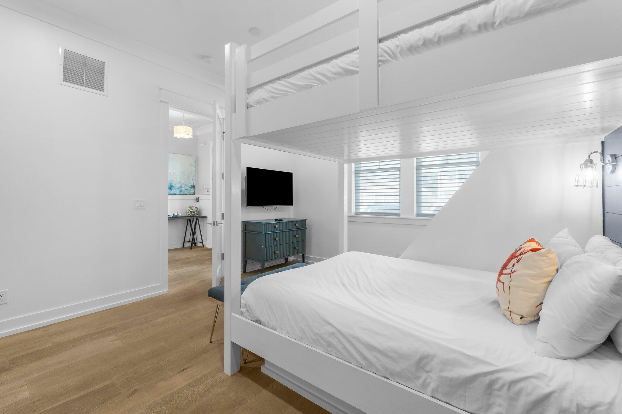 22015 Front Beach Road Panama City Beach, FL 32413 - Photo 92 of 104 a bedroom with a bed and a flat screen tv