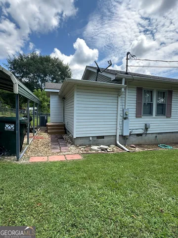 a backyard of a house with table and chairs