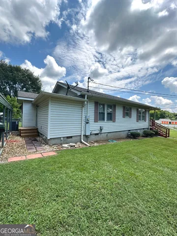 a view of yard with swimming pool and trees