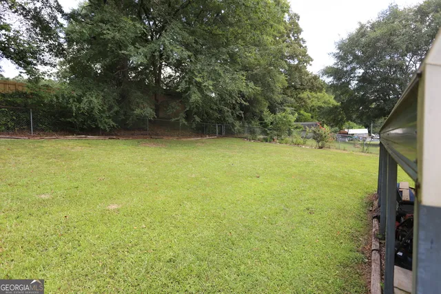 a view of a backyard with large trees