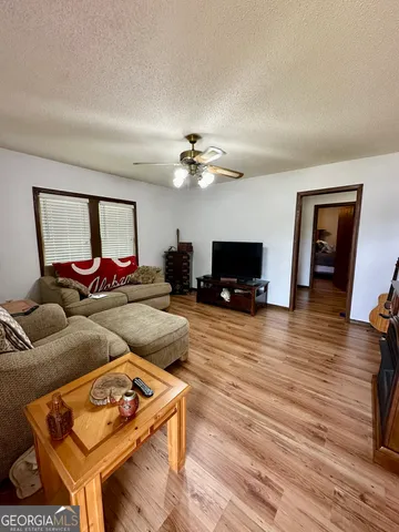 a living room with furniture and a flat screen tv
