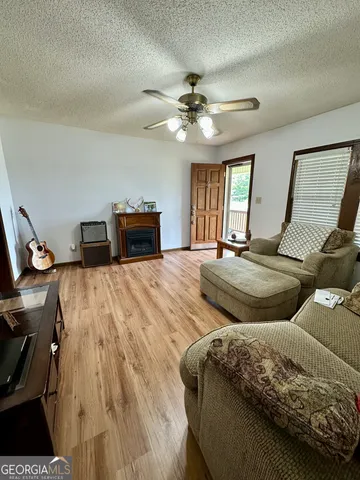 a living room with furniture and a chandelier