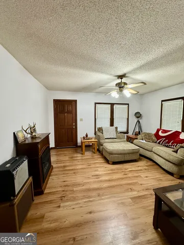 a living room with furniture and wooden floor