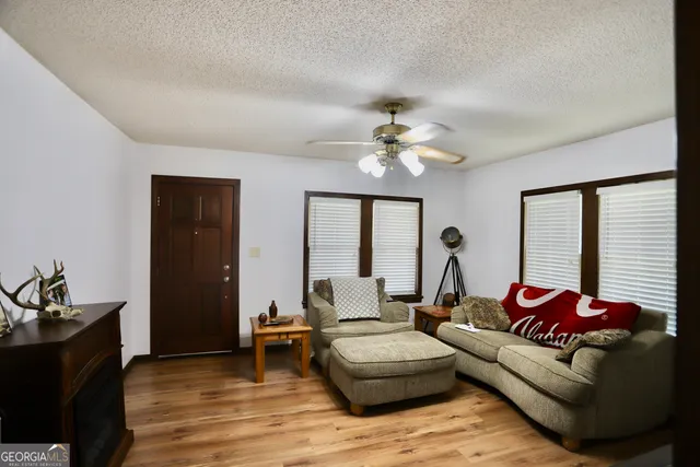 a living room with furniture and wooden floor