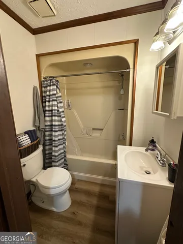 a view of bedroom with a bed and wooden floor