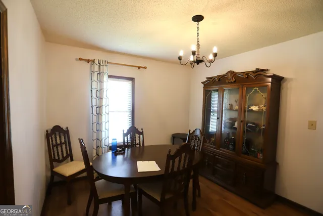 a kitchen with wooden floors a stove top oven a sink and a refrigerator