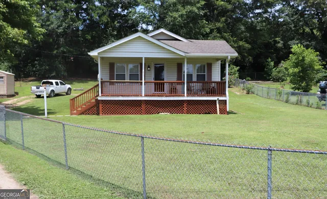 a front view of a house with a garden and porch