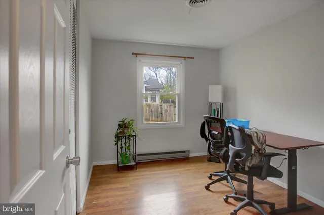 a view of a workspace with furniture and a window