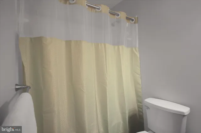 a bathroom with a shower curtain and sink
