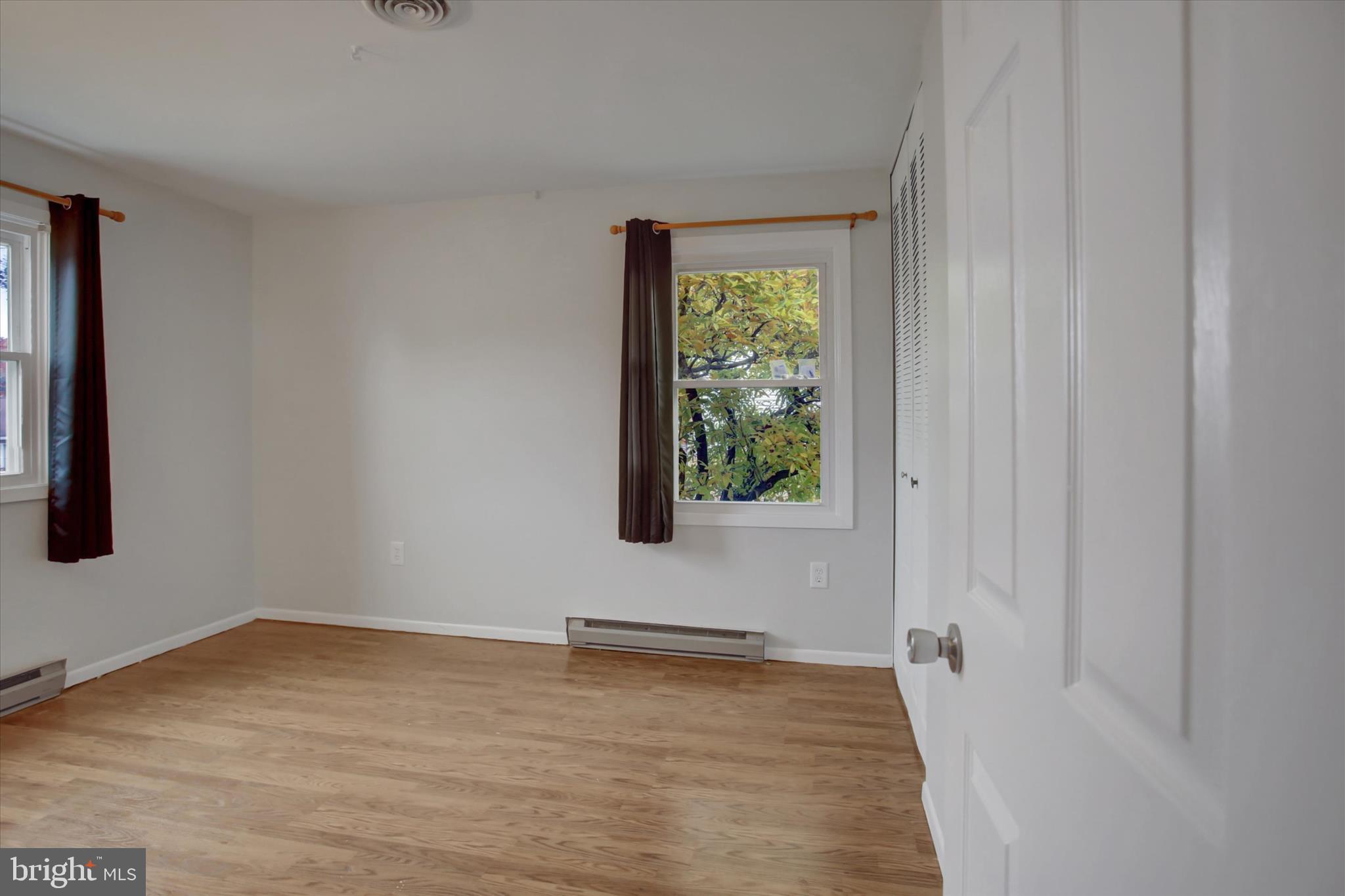 501 Cornell Avenue Hagerstown, MD 21742 - Photo 18 of 28 a view of an empty room with wooden floor and a window