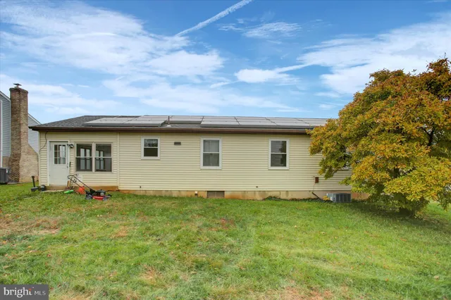 a backyard of a house with lots of green space and garden
