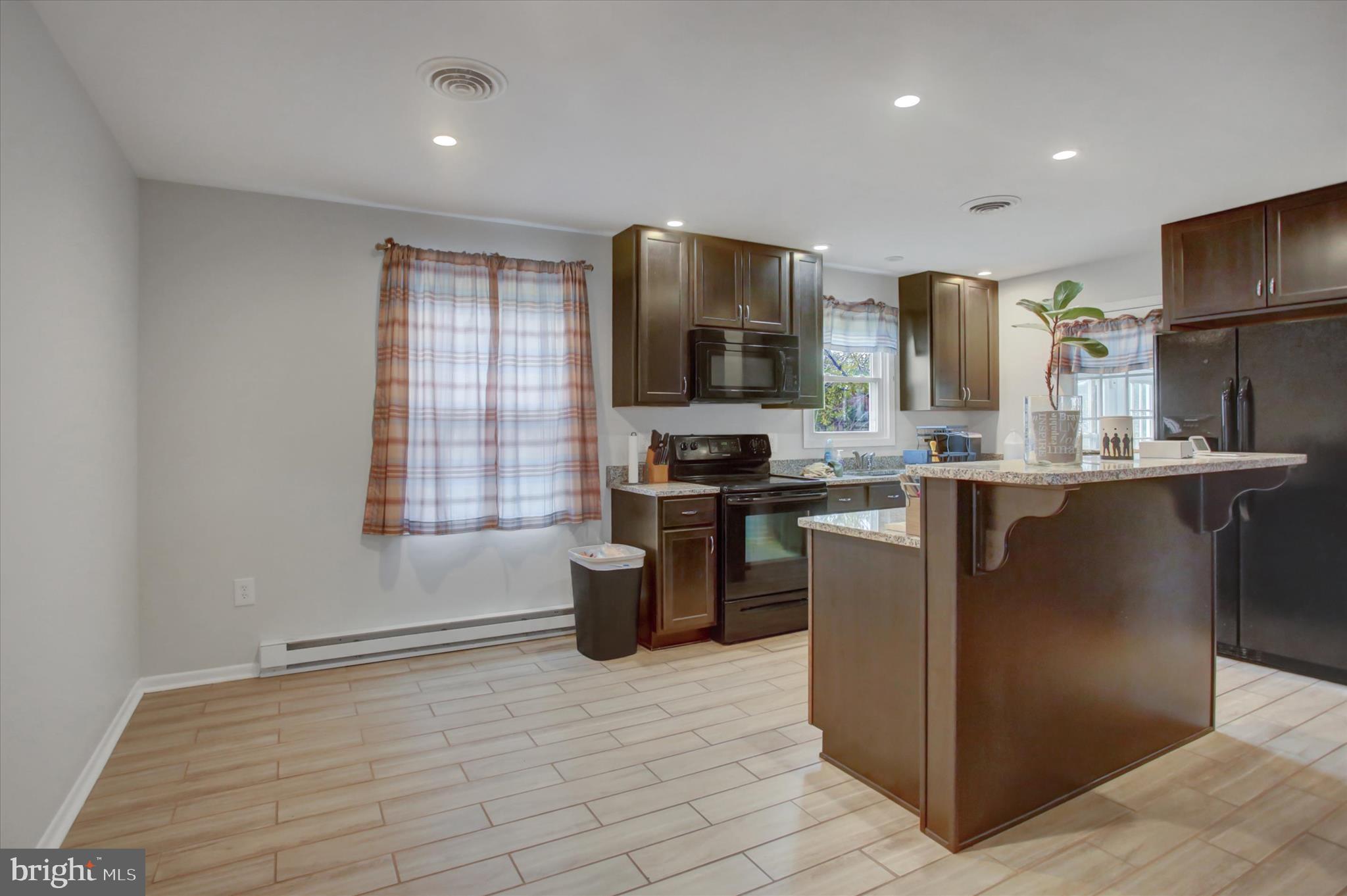 501 Cornell Avenue Hagerstown, MD 21742 - Photo 9 of 28 a kitchen with stainless steel appliances granite countertop a stove a sink a refrigerator and a microwave